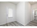 Foyer with white door, gray flooring, and a view of a half-bathroom at 431 Prescott Way, Villa Rica, GA 30180