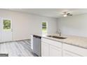 Kitchen island with granite countertop, sink, and dishwasher at 458 Prescott Way, Villa Rica, GA 30180