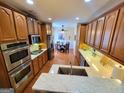 Spacious kitchen with stainless steel appliances and light wood cabinets at 511 Bonneset Ct, Canton, GA 30114