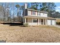 A charming two-story house with a well-maintained lawn and a welcoming front porch at 5427 Forest Pines Dr, Lithonia, GA 30058