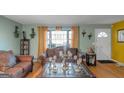 Living room with hardwood floors, brown leather couches, and decorative accents at 100 Traverse Ct, Atlanta, GA 30349