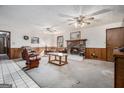 Carpeted living room with brick fireplace and ceiling fans at 255 Barnett Road Rd, Hampton, GA 30228