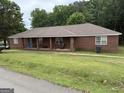Exterior view of the single-story brick home with covered porch at 241 E Ash St, Social Circle, GA 30025