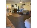 Living room with hardwood floors, a sofa, and a Christmas tree at 241 E Ash St, Social Circle, GA 30025