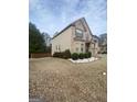 Well-maintained front yard featuring decorative landscaping and a lush lawn at 65 Waters Edge Ln, Covington, GA 30014