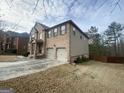 Side view of a brick home with a two-car garage and well-maintained lawn at 65 Waters Edge Ln, Covington, GA 30014