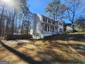 Two-story house with a red door and attached garage at 1879 Wrights Way, Jonesboro, GA 30236