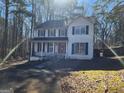 Two-story house with a red door and attached garage at 1879 Wrights Way, Jonesboro, GA 30236