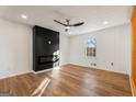 Bright living room featuring hardwood floors and a modern fireplace at 130 Belmont Farms Dr, Ellenwood, GA 30294