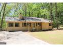 Inviting ranch-style home with a well-maintained lawn and a covered front porch in a tranquil setting at 1760 Upland Ridge Nw Dr, Conyers, GA 30012