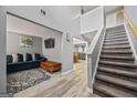View of open-plan living room featuring hardwood floors, staircase, and modern decor at 8264 Milam Loop, Fairburn, GA 30213