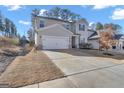 Charming two-story home with a well-maintained lawn and a two-car garage with a long driveway at 720 Lanarck Way, Peachtree City, GA 30269