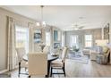 Open concept dining area with adjacent living space and fireplace at 1486 Trellis Court (Lot 43), Hampton, GA 30228