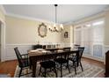 Formal dining room with hardwood floors, wainscoting, and a chandelier at 1152 Chadwick Lakes Dr, Lawrenceville, GA 30043