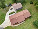 Beautiful aerial view of home with large lot, mature trees, detached garage and driveway at 5225 Bailey Sw Rd, Conyers, GA 30094