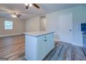 White kitchen cabinets and granite countertop island at 1198 E Atlanta Rd, Stockbridge, GA 30281