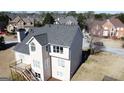 Rear view of a two-story house with a deck, white trim, and a well-maintained yard at 3226 Masters Pass Ln, Snellville, GA 30039