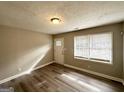 Spacious living area featuring hardwood floors and large windows at 50 Macon Se Pl, Atlanta, GA 30354