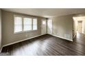 Bright living room featuring wood-look floors, neutral walls, and an interior door at 425 Cologne Se Dr, Atlanta, GA 30354