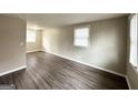 Spacious living room with neutral walls, wood-look floors, and large windows at 425 Cologne Se Dr, Atlanta, GA 30354