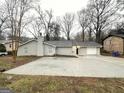 Newly renovated house with gray siding, a two-car garage, and a spacious front yard at 1351 Renee Dr, Decatur, GA 30035