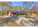 Front view of a ranch house with a long driveway at 305 Kelly Dr, Fayetteville, GA 30214