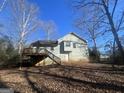 View of the home's back, showcasing a deck and stairs at 270 Mountain Way, Covington, GA 30016