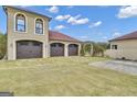 Three-car garage with stone paved driveway at 506 W Mcintosh Rd, Brooks, GA 30205