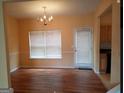 Bright dining room with hardwood floors and access to the backyard at 7777 Newbury Dr, Jonesboro, GA 30236
