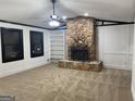 Living room featuring a stone fireplace and built-in shelving at 7280 Oswego Trl, Riverdale, GA 30296