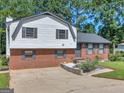 Two-story house featuring a brick and vinyl exterior, and a spacious yard at 5893 Nell Ln, Ellenwood, GA 30294