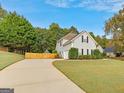 Long, paved driveway leads to a well-manicured yard, showcasing the home's exterior and surrounding landscape at 228 Otter Cir, Fayetteville, GA 30215