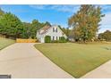 House with driveway and attached garage, surrounded by trees at 228 Otter Cir, Fayetteville, GA 30215