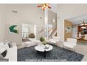 Bright, open-concept living room with high ceilings, modern furnishings, and seamless flow to other living spaces at 228 Otter Cir, Fayetteville, GA 30215