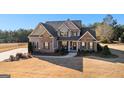 Two-story house with brick and siding, a covered porch, and a landscaped lawn at 250 Enfield Ln, Mcdonough, GA 30252