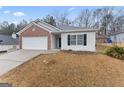 Two-car garage and front yard with landscaping at 10231 Deep Creek Pl, Union City, GA 30291