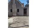 Rear exterior of house with small patio and brick chimney at 4031 S Old Fairburn Road S Rd, South Fulton, GA 30349