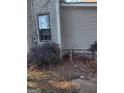 Side of house with window and overgrown bushes at 4031 S Old Fairburn Road S Rd, South Fulton, GA 30349