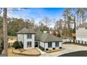 Two-story house with a gray roof and white exterior, nicely landscaped at 103 Sandtrap Rdg, Peachtree City, GA 30269