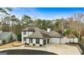 Two-story house with a gray roof, white exterior, and a two-car garage at 103 Sandtrap Rdg, Peachtree City, GA 30269