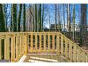 Wooden deck with railings overlooks a wooded backyard at 1979 Cardell Rd # 20, Austell, GA 30168