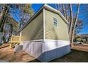 Side view of the mobile home showcasing its green siding and deck at 1979 Cardell Rd # 20, Austell, GA 30168