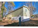 Another side view of the mobile home, highlighting its rear deck and AC unit at 1979 Cardell Rd # 20, Austell, GA 30168