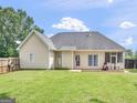 Spacious backyard featuring a well-maintained lawn, wooden deck, and full fence, perfect for outdoor enjoyment at 2110 Kellington Dr, Mcdonough, GA 30253