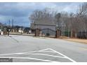 Gated community entrance with black metal gates and brick pillars at 128 Lavender Way # 75, Mcdonough, GA 30252