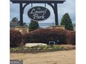 Laurel Park neighborhood sign surrounded by manicured shrubbery and flowers at 128 Lavender Way # 75, Mcdonough, GA 30252