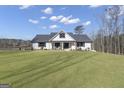 Beautifully landscaped front yard showcasing the home's modern farmhouse design at 459 Lester Rd, Fayetteville, GA 30215