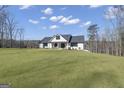 Well-manicured lawn leads to a charming modern farmhouse at 459 Lester Rd, Fayetteville, GA 30215