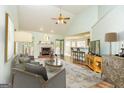 Spacious living room featuring a fireplace, ceiling fan, and open access to the kitchen at 67 Kentucky Ave, Sharpsburg, GA 30277