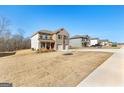 A view of several attractive homes in a well-kept neighborhood under a bright sky at 755 Gelderland Dr, Hampton, GA 30228